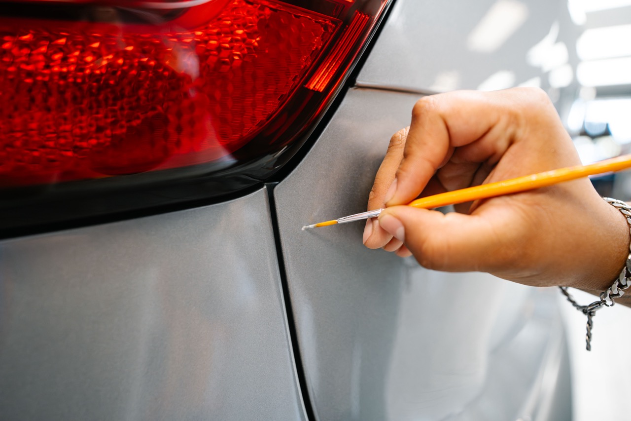 Fixing a scratch on a car's paint with touch-up work
